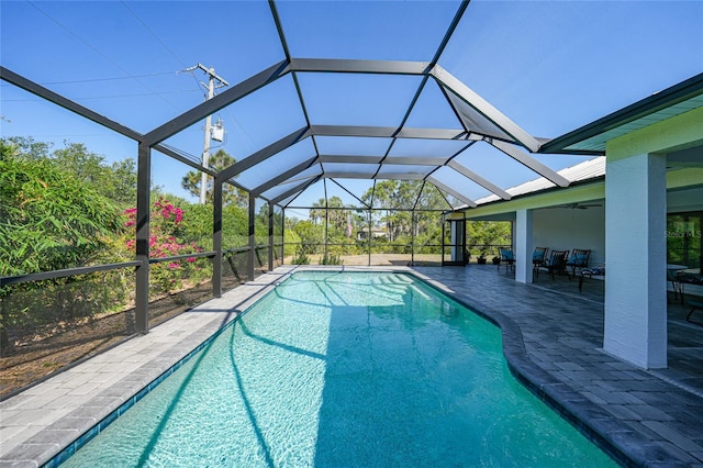 2957 Montgomery Dr, Port Charlotte, FL 33981 - outdoor pool featuring glass enclosure, ceiling fan, and a patio area
