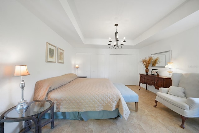 2957 Montgomery Dr, Port Charlotte, FL 33981 - bedroom featuring multiple closets, a tray ceiling, and a notable chandelier