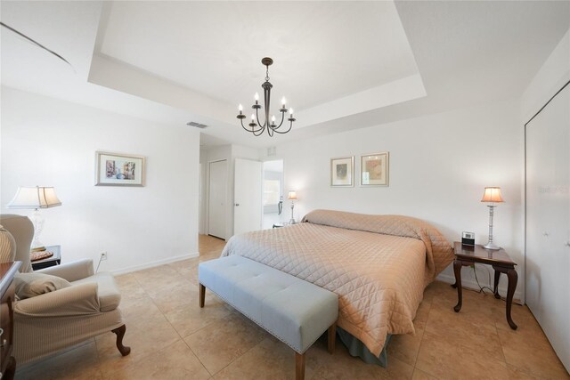 2957 Montgomery Dr, Port Charlotte, FL 33981 - bedroom featuring an inviting chandelier, light tile patterned floors, a tray ceiling, and visible vents