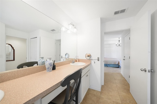 2957 Montgomery Dr, Port Charlotte, FL 33981 - ensuite bathroom with visible vents, tile patterned flooring, vanity, baseboards, and ensuite bath