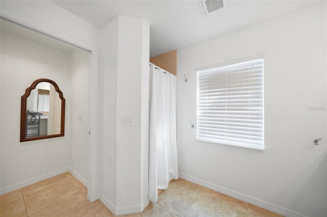 2957 Montgomery Dr, Port Charlotte, FL 33981 - hallway with baseboards, visible vents, and tile patterned floors