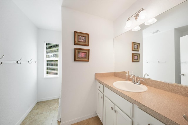 2957 Montgomery Dr, Port Charlotte, FL 33981 - bathroom featuring baseboards, visible vents, tile patterned flooring, and vanity