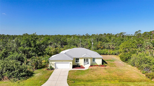 2957 Montgomery Dr, Port Charlotte, FL 33981 - view of front facade with a garage, a view of trees, a front lawn, and concrete driveway