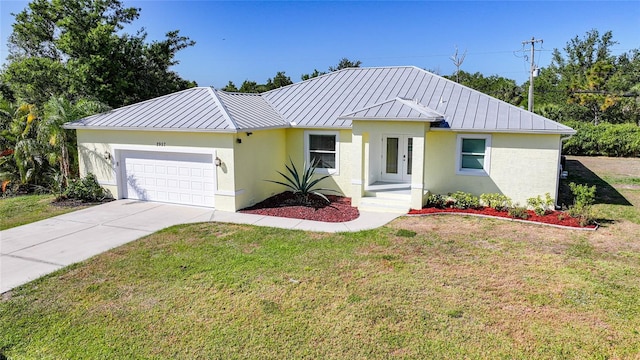 2957 Montgomery Dr, Port Charlotte, FL 33981 - view of front of home with a garage, a front lawn, metal roof, and a standing seam roof