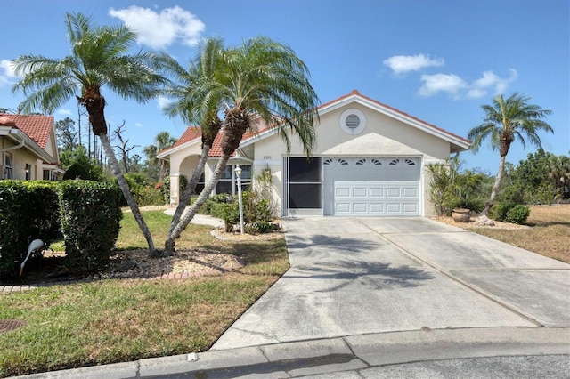 mediterranean / spanish-style home featuring an attached garage, driveway, and stucco siding