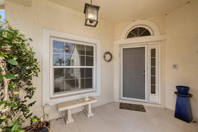 view of exterior entry featuring stucco siding
