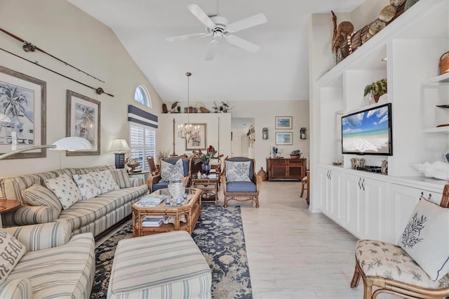living area featuring high vaulted ceiling, light wood-style flooring, and ceiling fan with notable chandelier
