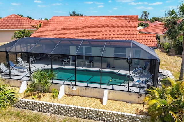 outdoor pool featuring a patio area and a lanai