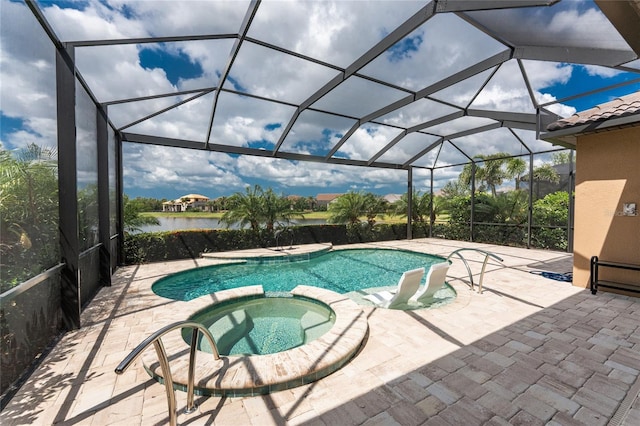 view of swimming pool featuring a pool with connected hot tub, a patio, and a lanai