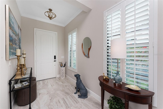 foyer entrance with ornamental molding, marble look tiles, and baseboards