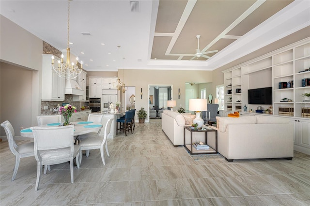 living room featuring a chandelier, ceiling fan, crown molding, and recessed lighting