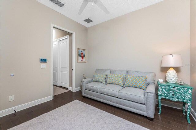 living area with wood finished floors, baseboards, and ceiling fan