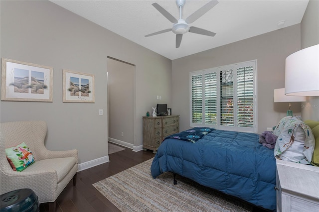 bedroom with wood finished floors, baseboards, and a ceiling fan