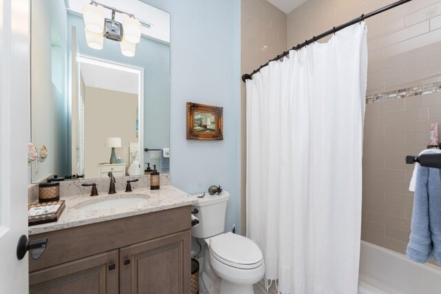 full bathroom featuring vanity, toilet, and shower / bathtub combination with curtain