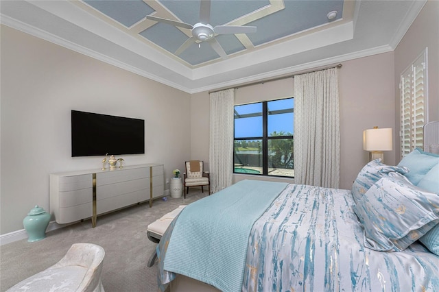carpeted bedroom featuring a tray ceiling, crown molding, a ceiling fan, and baseboards