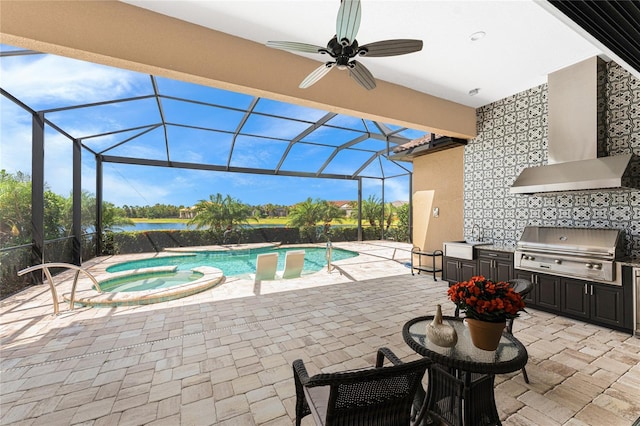 view of swimming pool with an outdoor kitchen, grilling area, a patio area, and a sink