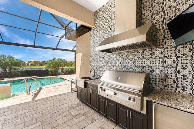 view of patio with a sink, exterior kitchen, a grill, an outdoor pool, and glass enclosure