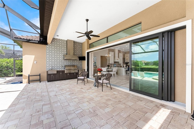 view of patio featuring an outdoor kitchen, area for grilling, a lanai, and ceiling fan