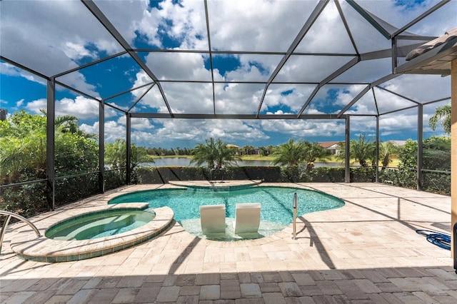 view of pool with glass enclosure, a pool with connected hot tub, a patio area, and a water view