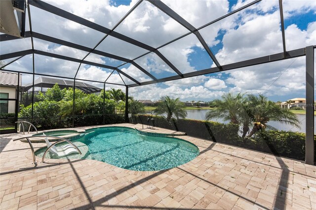 view of pool with a patio area, a pool with connected hot tub, a water view, and a lanai