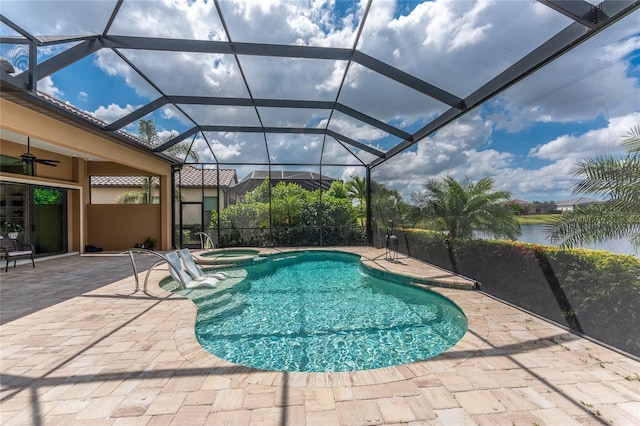 view of pool with a patio, ceiling fan, a pool with connected hot tub, and a water view