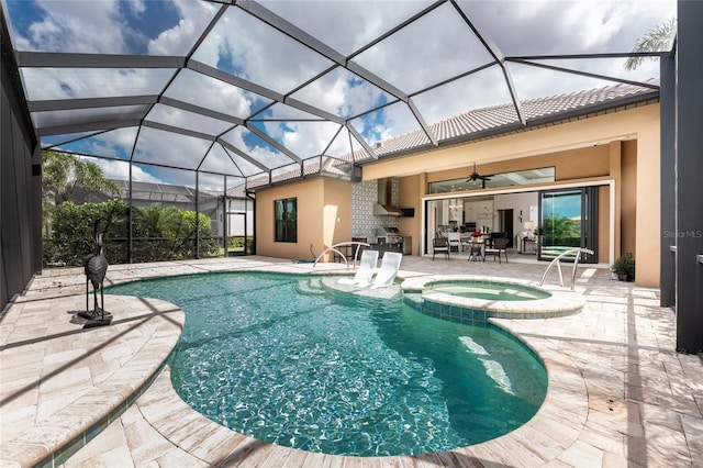 view of swimming pool with a patio area, ceiling fan, a pool with connected hot tub, and a lanai