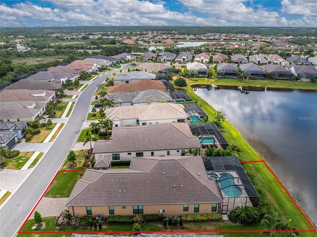 aerial view of residential area featuring property parcel outlined and a large body of water