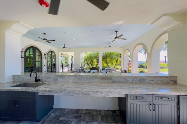 kitchen featuring a sink, plenty of natural light, light stone countertops, and recessed lighting
