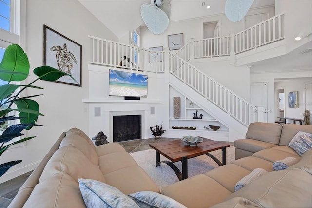 6890 Palm Island Dr, Placida, FL 33946 - living room with stairway, a high ceiling, and a fireplace