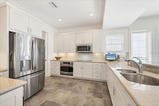 6890 Palm Island Dr, Placida, FL 33946 - kitchen featuring visible vents, appliances with stainless steel finishes, crown molding, and a sink