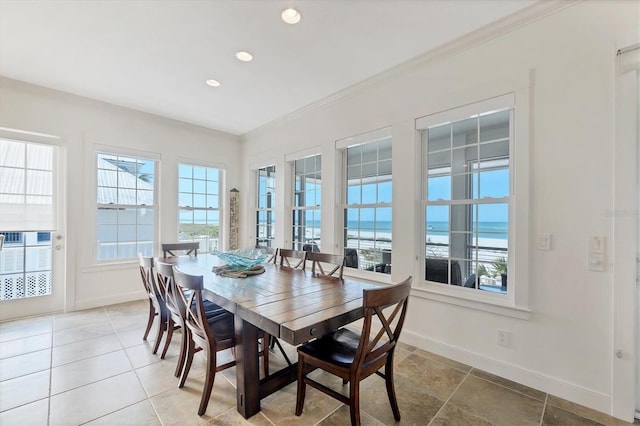 6890 Palm Island Dr, Placida, FL 33946 - tiled dining room featuring a healthy amount of sunlight, recessed lighting, ornamental molding, and baseboards