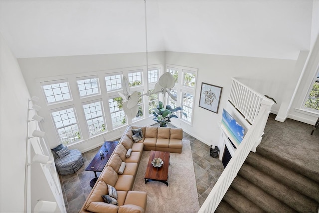 6890 Palm Island Dr, Placida, FL 33946 - living area featuring baseboards, high vaulted ceiling, and stairway