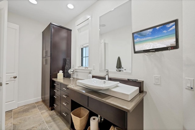 6890 Palm Island Dr, Placida, FL 33946 - bathroom with stone finish floor, vanity, and baseboards