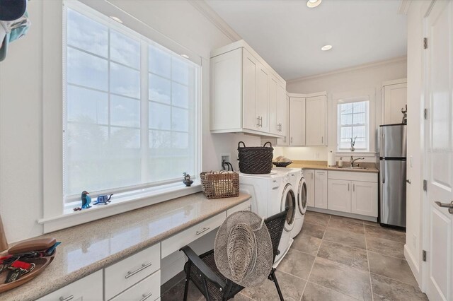 6890 Palm Island Dr, Placida, FL 33946 - laundry room with independent washer and dryer, crown molding, a sink, stone finish flooring, and cabinet space