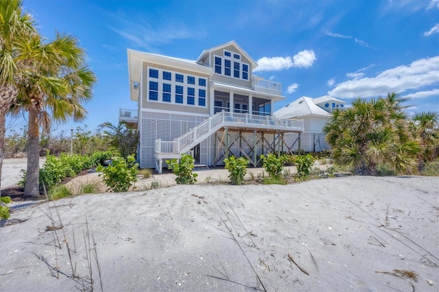 6890 Palm Island Dr, Placida, FL 33946 - back of property featuring a porch, stairway, and a balcony