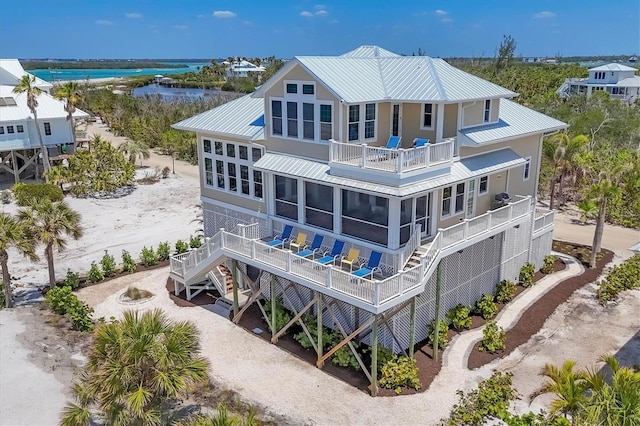 6890 Palm Island Dr, Placida, FL 33946 - rear view of house with a balcony, metal roof, a water view, and stairs