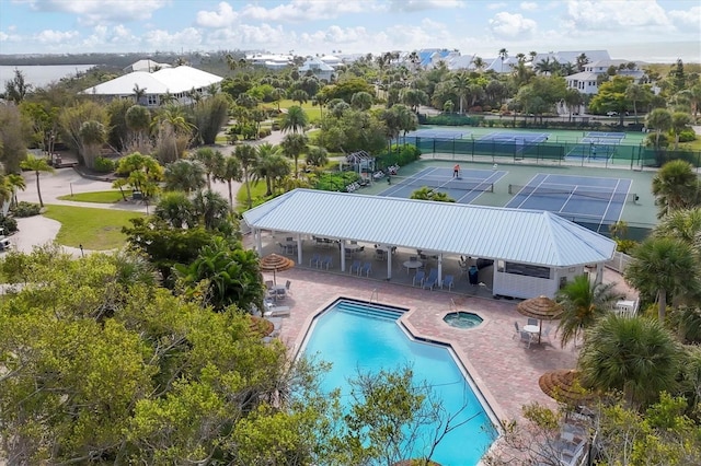 6890 Palm Island Dr, Placida, FL 33946 - community pool featuring a tennis court, fence, a community hot tub, and a patio