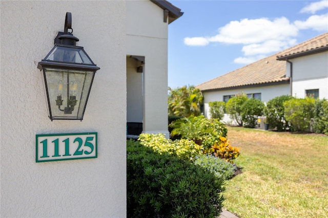 11125 Mcdermott Ct, Englewood, FL 34223 - view of property exterior featuring a lawn and stucco siding
