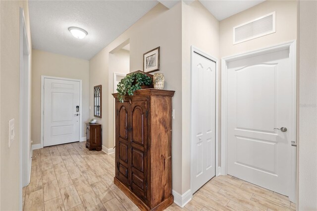 11125 Mcdermott Ct, Englewood, FL 34223 - hall featuring visible vents, baseboards, and light wood-type flooring