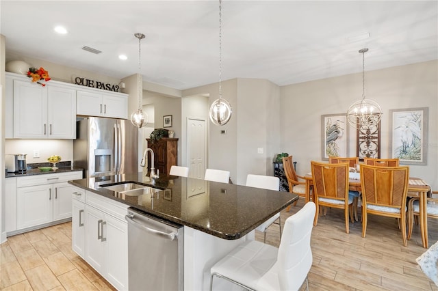 11125 Mcdermott Ct, Englewood, FL 34223 - kitchen featuring visible vents, light wood-type flooring, a chandelier, a sink, and appliances with stainless steel finishes