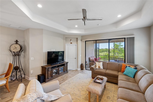11125 Mcdermott Ct, Englewood, FL 34223 - living room with a raised ceiling, baseboards, recessed lighting, and light wood-style flooring