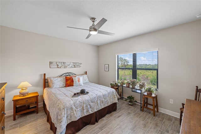 11125 Mcdermott Ct, Englewood, FL 34223 - bedroom featuring baseboards, ceiling fan, and light wood-style flooring