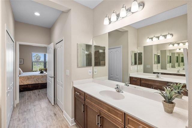11125 Mcdermott Ct, Englewood, FL 34223 - ensuite bathroom with a sink, baseboards, two vanities, and connected bathroom