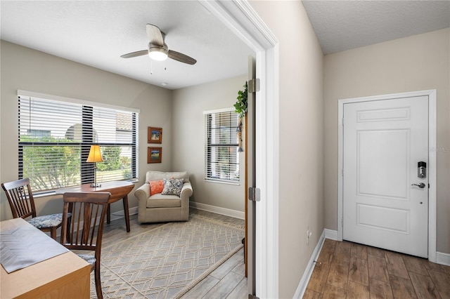 11125 Mcdermott Ct, Englewood, FL 34223 - office area featuring baseboards, a ceiling fan, and light wood-type flooring