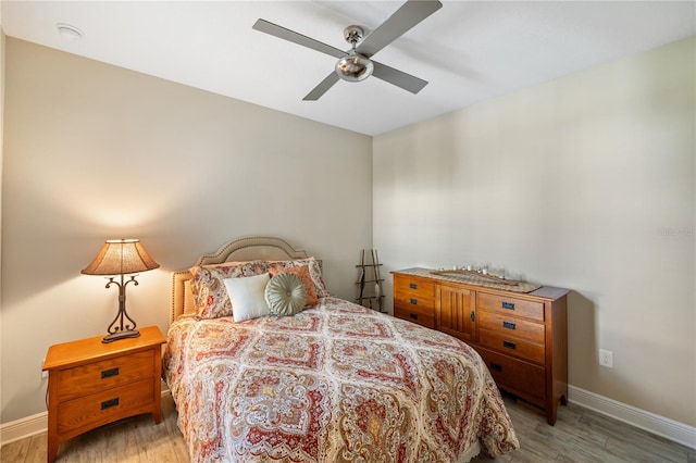 11125 Mcdermott Ct, Englewood, FL 34223 - bedroom with baseboards, ceiling fan, and wood finished floors