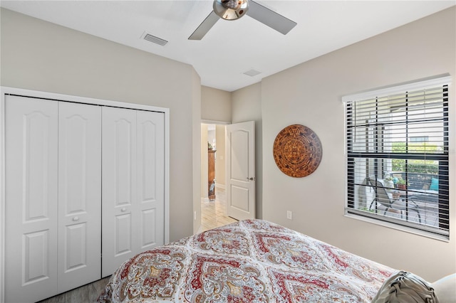 11125 Mcdermott Ct, Englewood, FL 34223 - bedroom with ceiling fan, a closet, wood finished floors, and visible vents