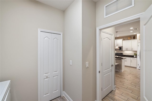 11125 Mcdermott Ct, Englewood, FL 34223 - hallway with light wood-style floors, recessed lighting, baseboards, and visible vents