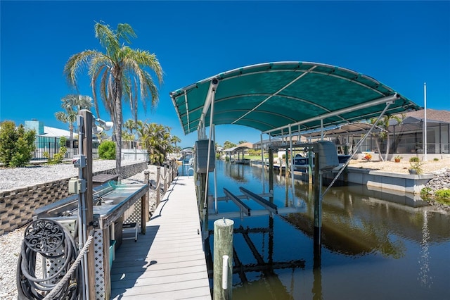 dock area featuring boat lift and a water view