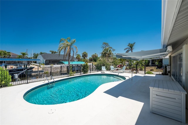 view of swimming pool featuring a patio, fence, and a fenced in pool