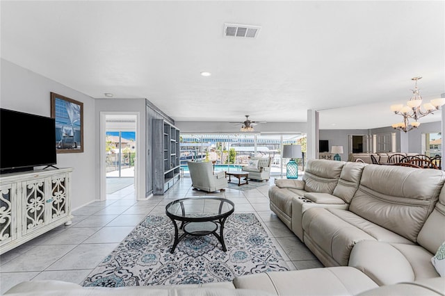 living area featuring a wealth of natural light, light tile patterned flooring, and visible vents